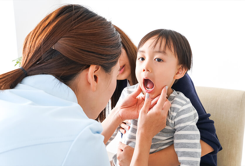 young boy having his teeth examined by a dentist