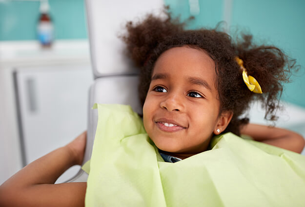 young girl sitting in a dental chair